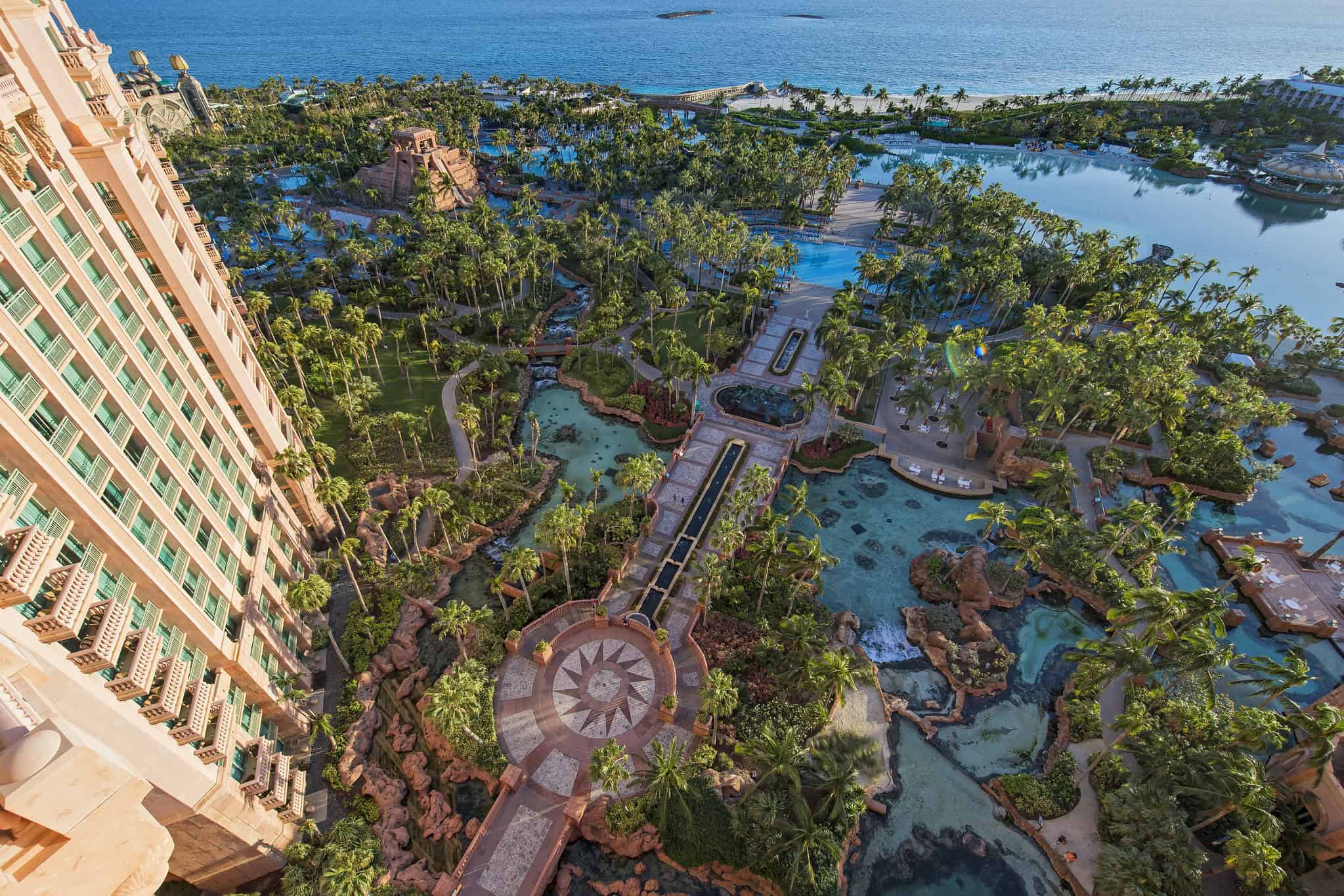 looking down on resort swimming pools from high floor of hotel